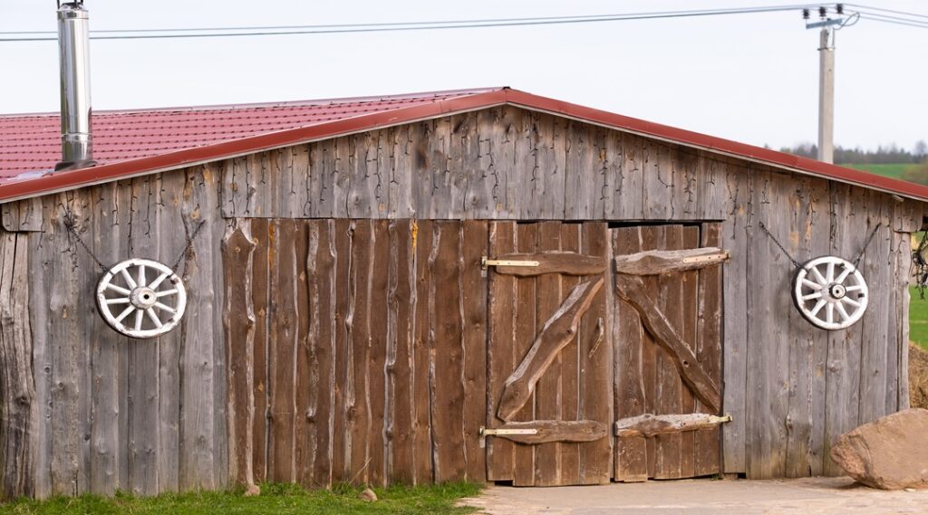 An old barn on the ranch. Large wooden gates and dried wood.